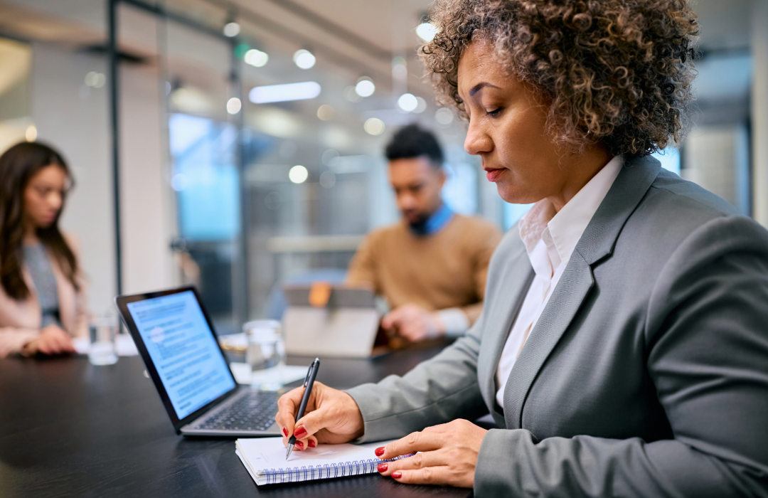 Lady writing notes in an office